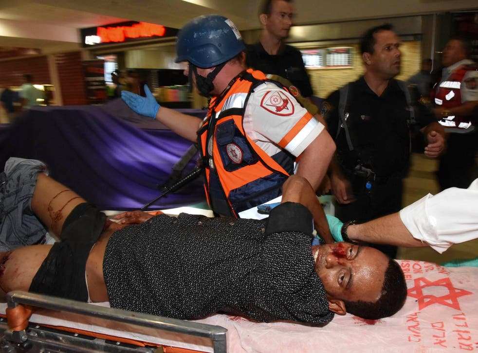 Mulu Habtom Zerhoma, a wounded Eritrean, is evacuated from the scene of an attack in Beersheba