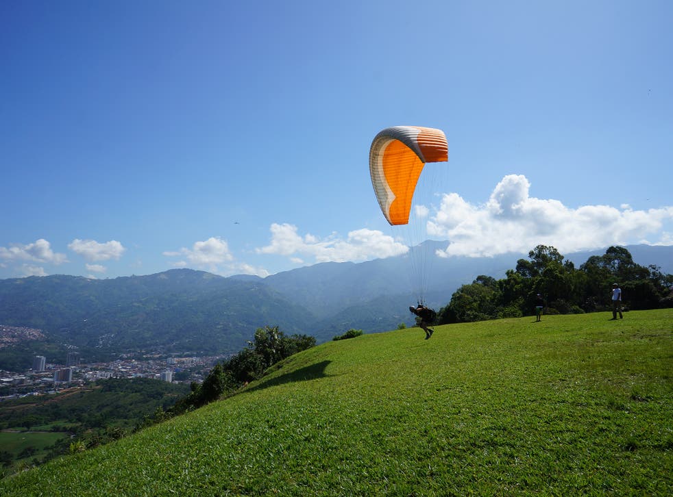 Blue sky thinking: a paraglider takes off