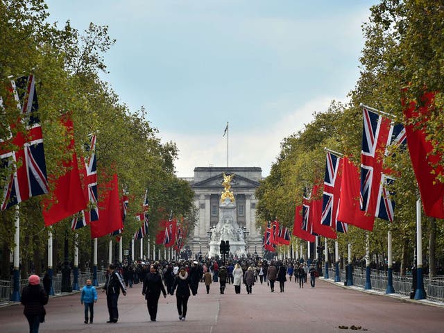 British Union flags and Chinese flags fly together on the Mall in central London, on October 18, 2015.
