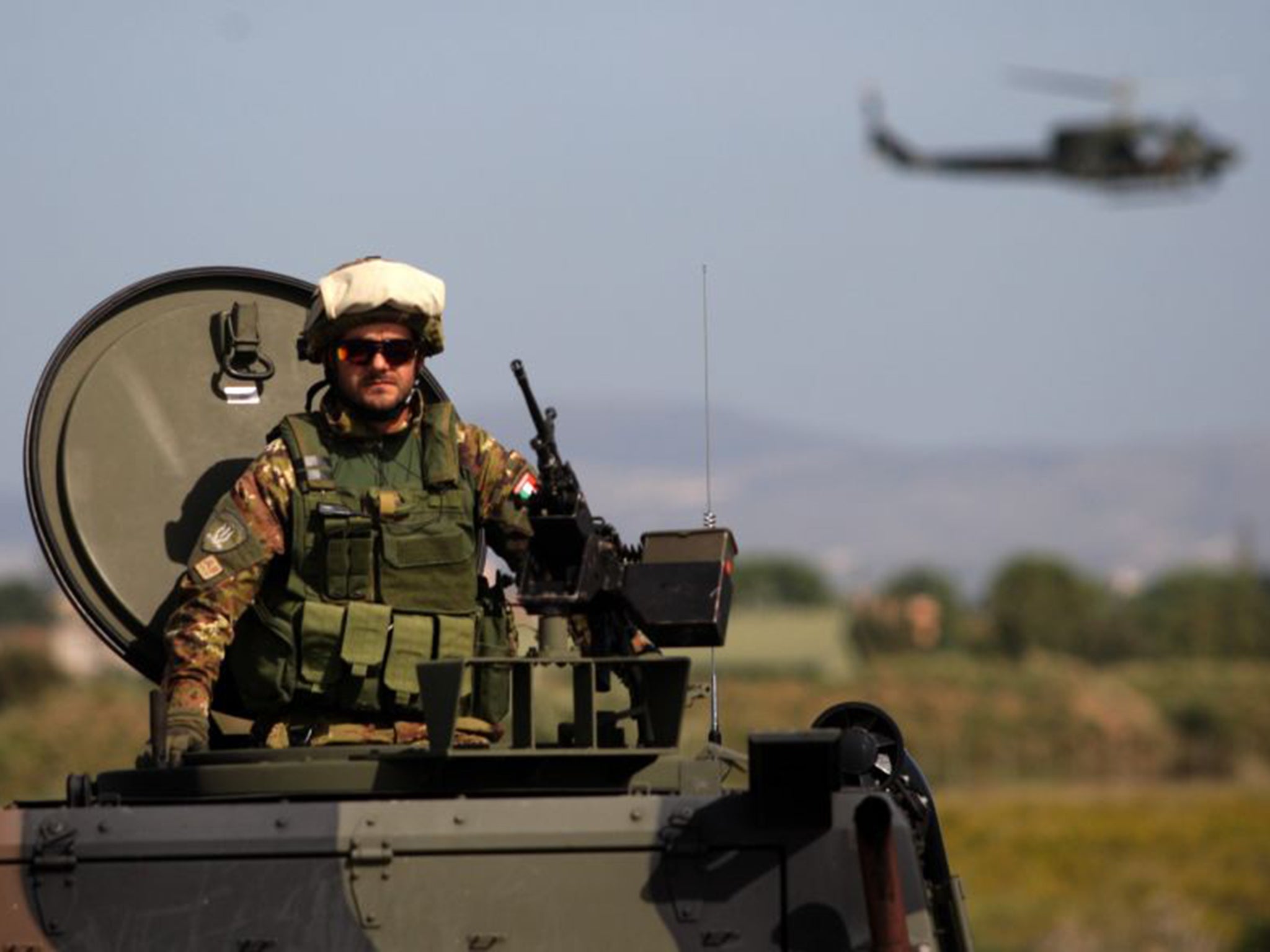 An Italian soldier mans an armoured vehicle during the opening ceremony of NATO's large scale exercise at the Italian Air Force Base in Trapani, Sicily