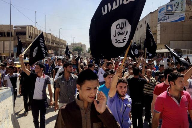 Crowds with Isis flags march in Mosul, Iraq. But what should we call the extremist 'caliphate' in the Middle East?