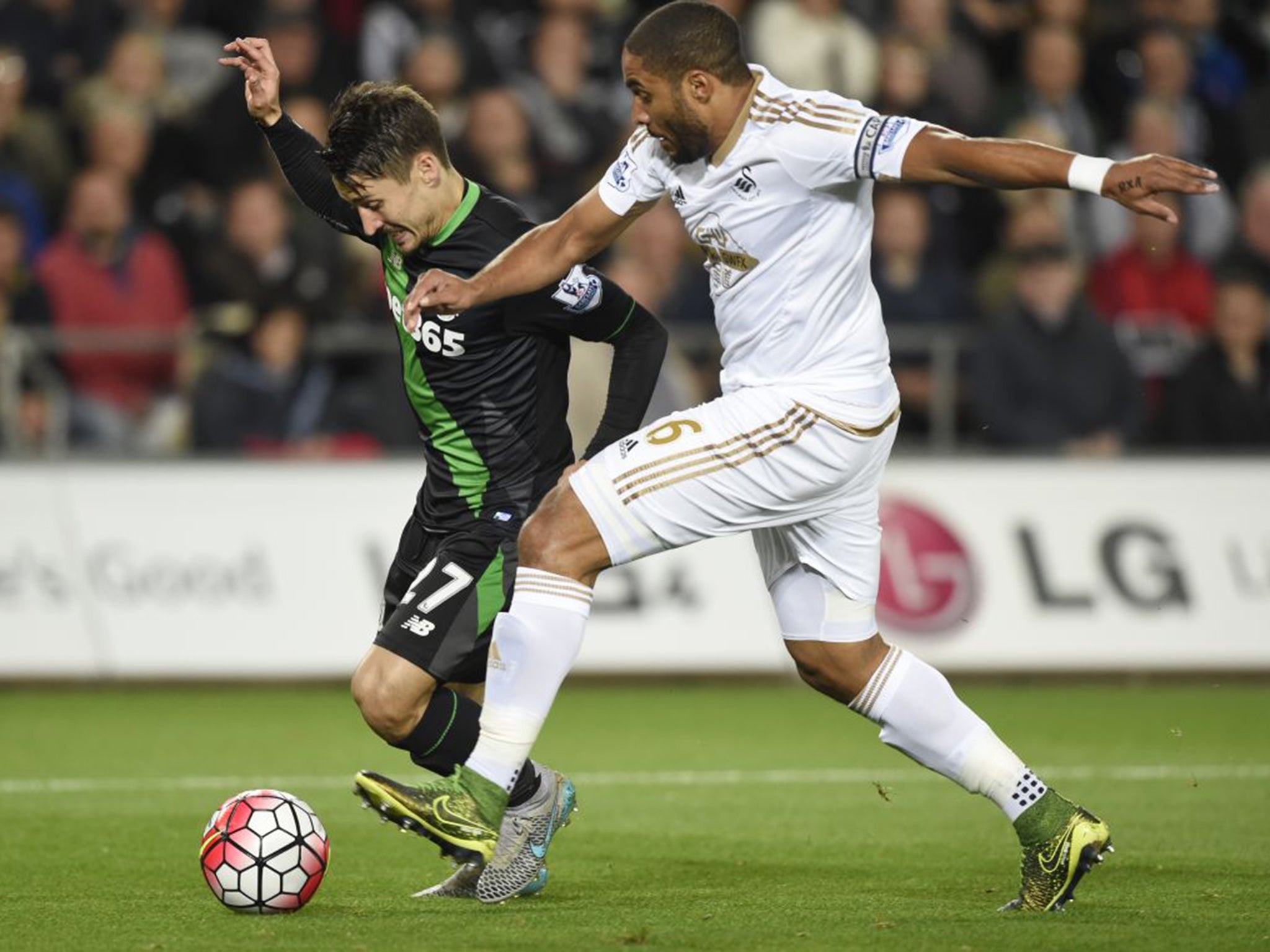 Swansea defender Ashley Williams brings down Stoke’s Bojan Krkic for the match-winning penalty at the Liberty Stadium