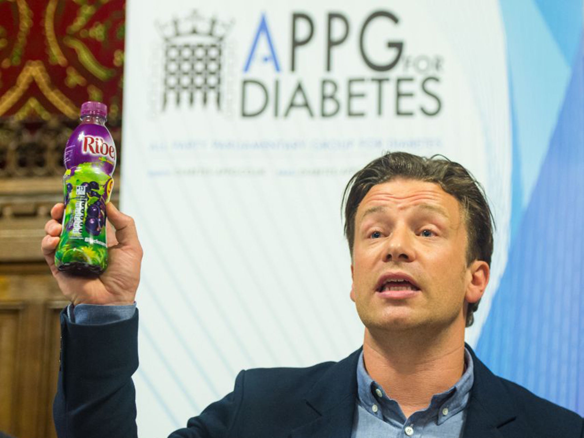 Jamie Oliver holds up a bottle of Ribena as he speaks at a meeting of the All Party Parliamentary Group for Diabetes at the House of Commons