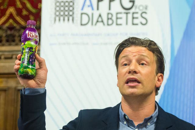 Jamie Oliver holds up a bottle of Ribena as he speaks at a meeting of the All Party Parliamentary Group for Diabetes at the House of Commons
