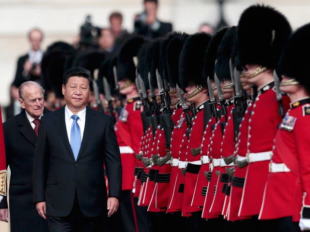 China's President Xi Jinping and Britain's Prince Philip review an honour guard during his official welcoming ceremony in London