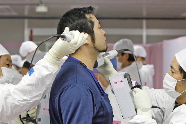 A worker undergoes radiation screening as he enters the emergency operation centre at the Fukushima Daiichi plant in February 2012, 11 months after the catastrophe