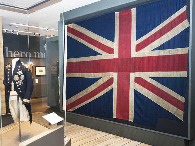 Lord Nelson's uniform next to the Union flag, previously flown at the Battle of Trafalgar, which will go on display to the public at the National Maritime Museum