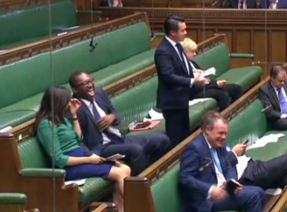 Kwasi Kwarteng is seen laughing with another MP during the debate