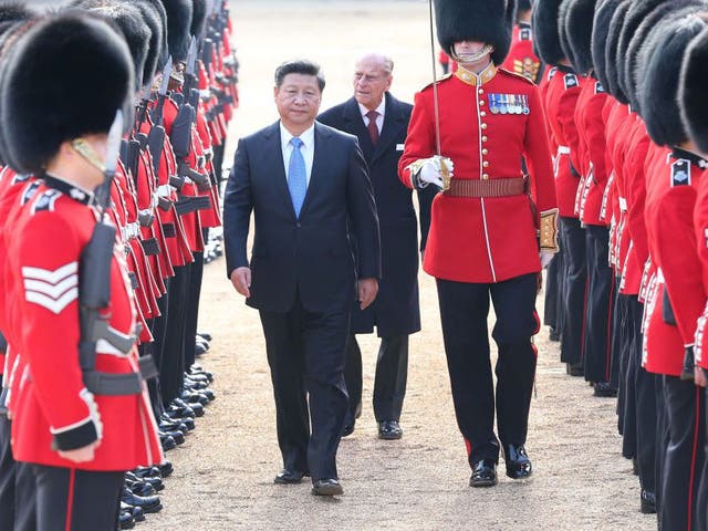 Chinese President Xi Jinping, accompanied by Prince Philip, inspects the guard of honor during a traditional ceremonial welcome held by British Queen Elizabeth II at the Horse Guards Parade in London, Britain, Oct. 20, 2015.
