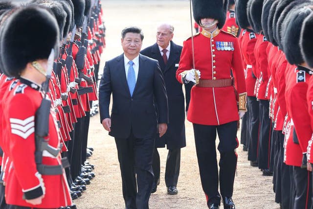 Chinese President Xi Jinping, accompanied by Prince Philip, inspects the guard of honor during a traditional ceremonial welcome held by British Queen Elizabeth II at the Horse Guards Parade in London, Britain, Oct. 20, 2015.