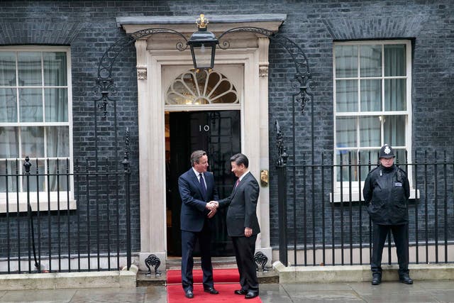China's President Xi Jinping is welcomed by Britain's Prime Minister David Cameron to 10 Downing Street, in central London