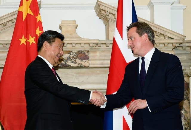 The  Prime Minister shakes hands with the President Xi Jinping during a commercial contract exchange at the UK-China Business Summit in Mansion House