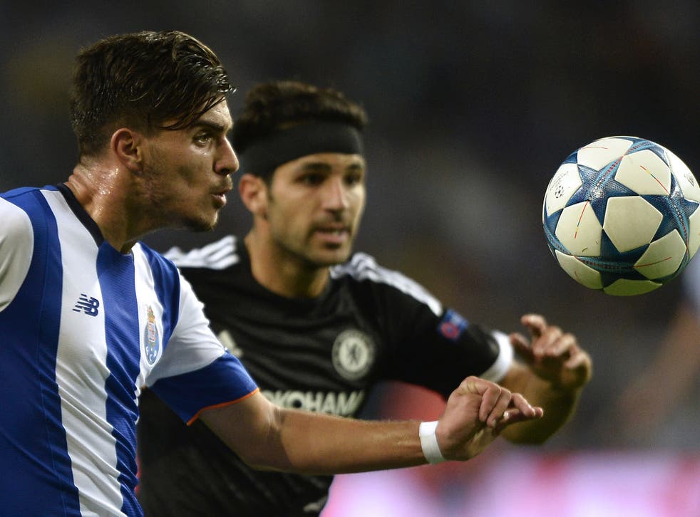 Ruben Neves competes with Cesc Fabregas for the ball