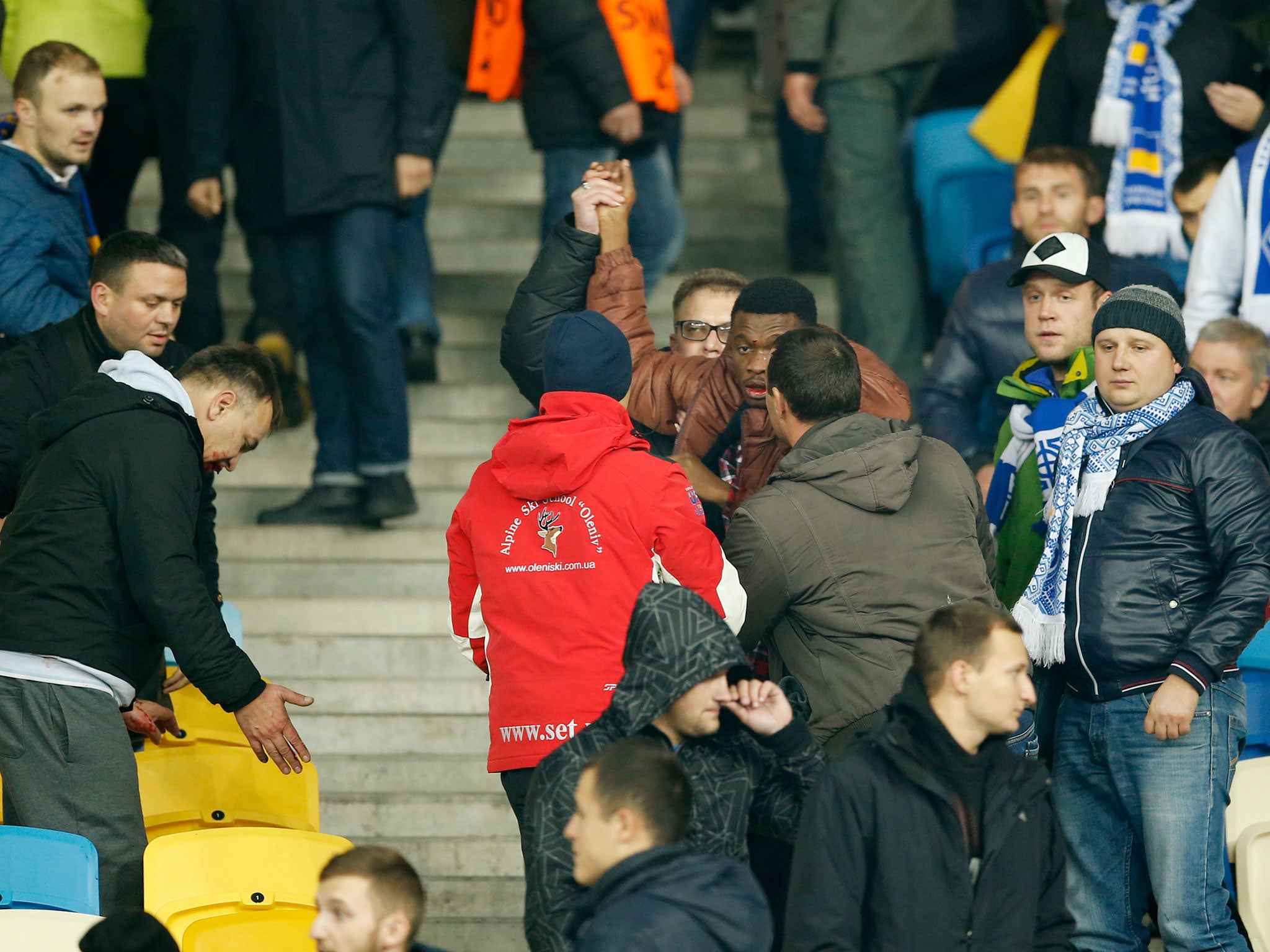 A black man tries to flee the stands at the NSK Olimpiysky after being attacked in an apparent racial assault