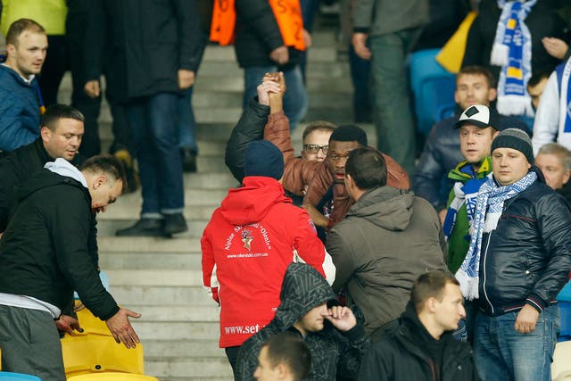 A black man tries to flee the stands at the NSK Olimpiysky after being attacked in an apparent racial assault