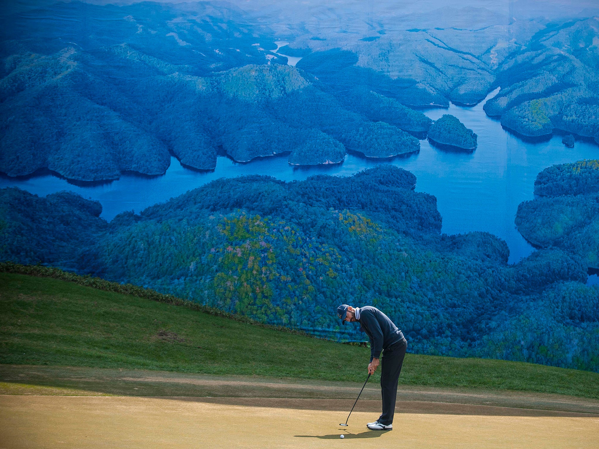 A player puts on the green at the Dragon Lake Golf Club in Guangzhou, China. Golf is seen as providing an opportunity for officials to make shady deals and an extravagance for government employees who should be serving the people