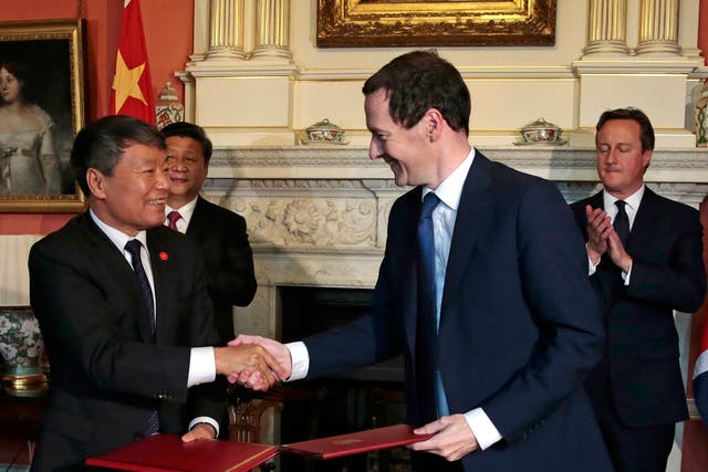 Geroge Osborne and China's Xu Shaoshi shake hands after signing an agreement
