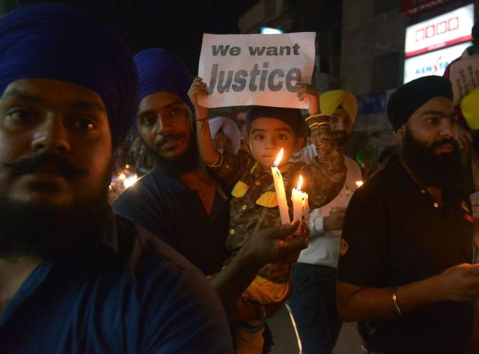 Indian Sikhs attend a candle-lit march in Amritsar, Punjab. The protesters in London were holding a march to support those in India