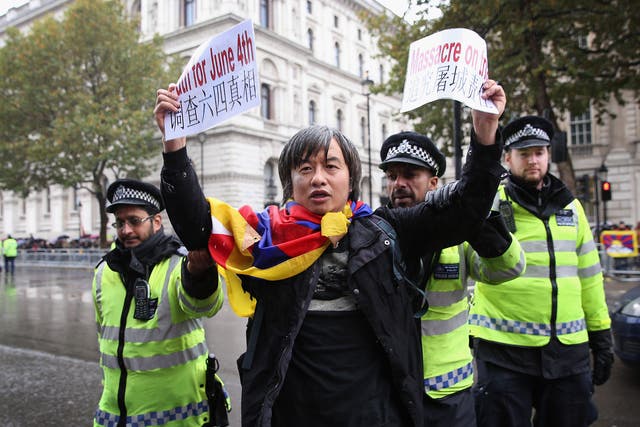 Tiananmen Square survivor Shao Jiang was arrested in the street road for holding up protest banners in Central London
