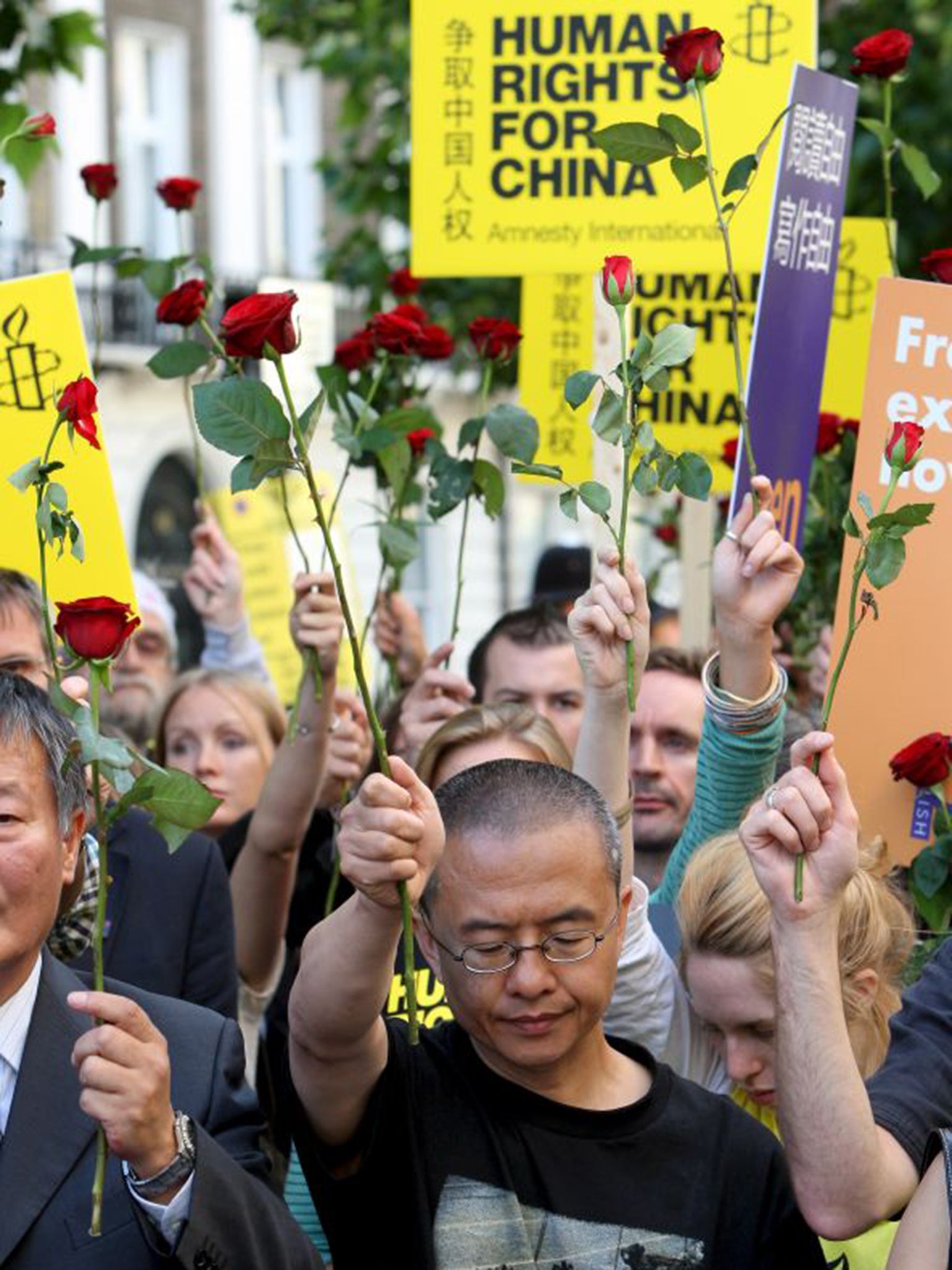 Shao Jiang holds up a rose along with other demonstrators outside the Chinese Embassy to mark the 19th anniversary of the Tiananmen Square crackdown in London in 2008