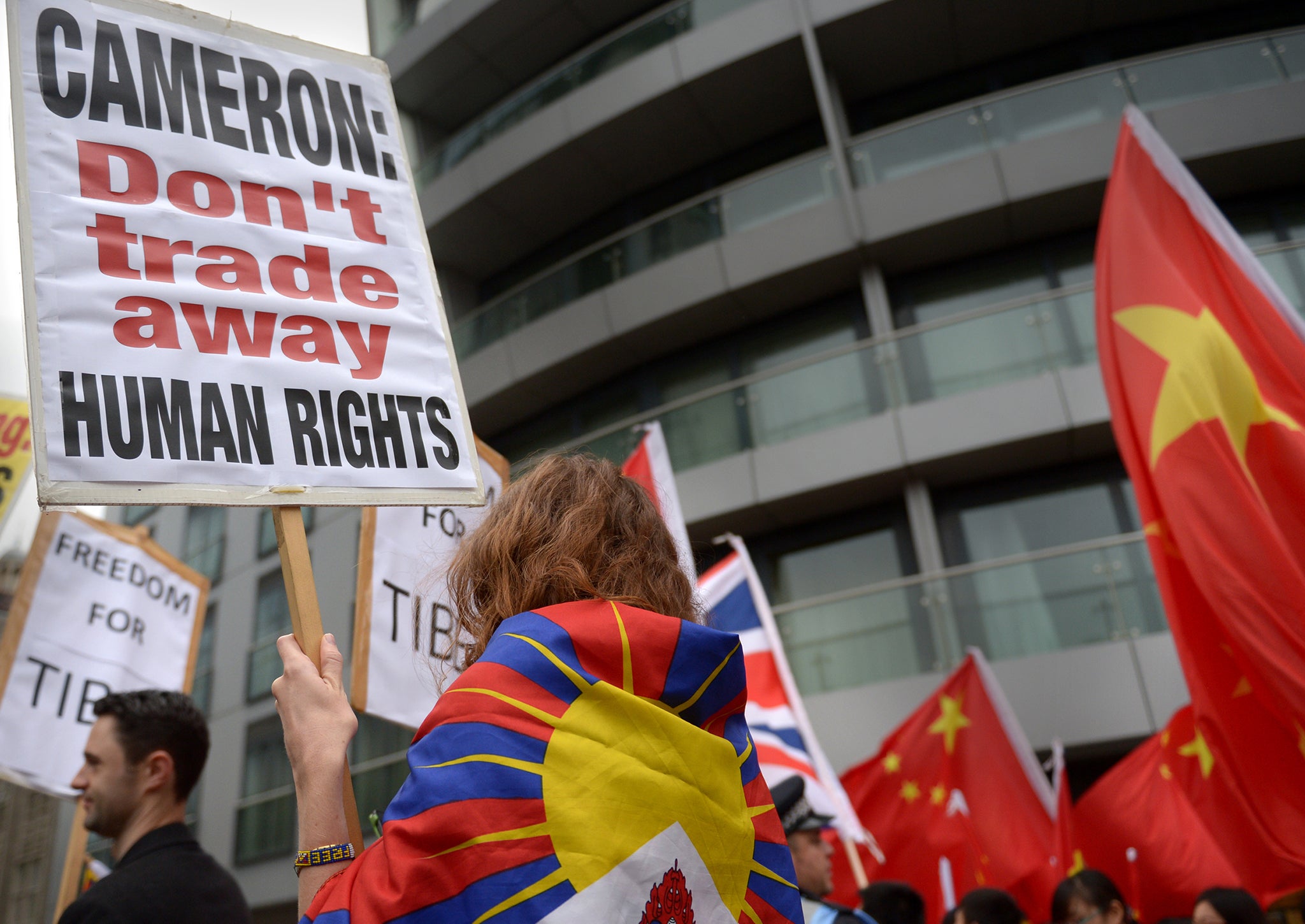 Demonstrators hold placards at a protest against the Chinese state visit in London, held in 2015