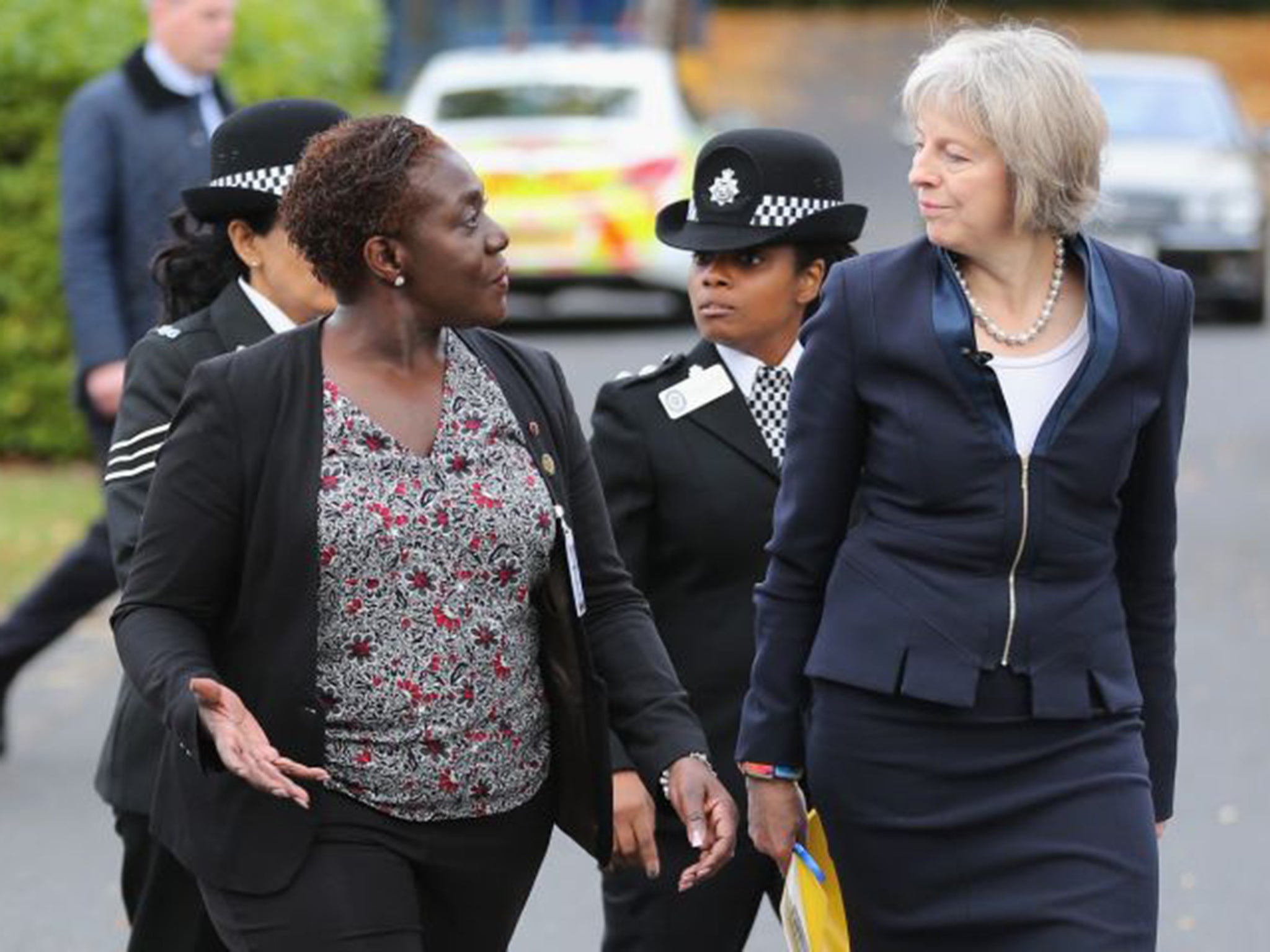 Home Secretary Theresa May, not always on the best of terms with the police, arrives at the National Black Police Association conference in Birmingham, escorted by NBPA chair Franstine Jones
