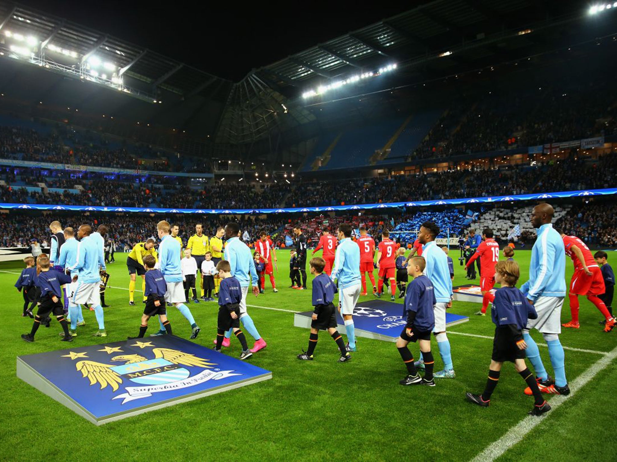 The teams walk out before the Champions League game between Manchester City and Sevilla on Wednesday
