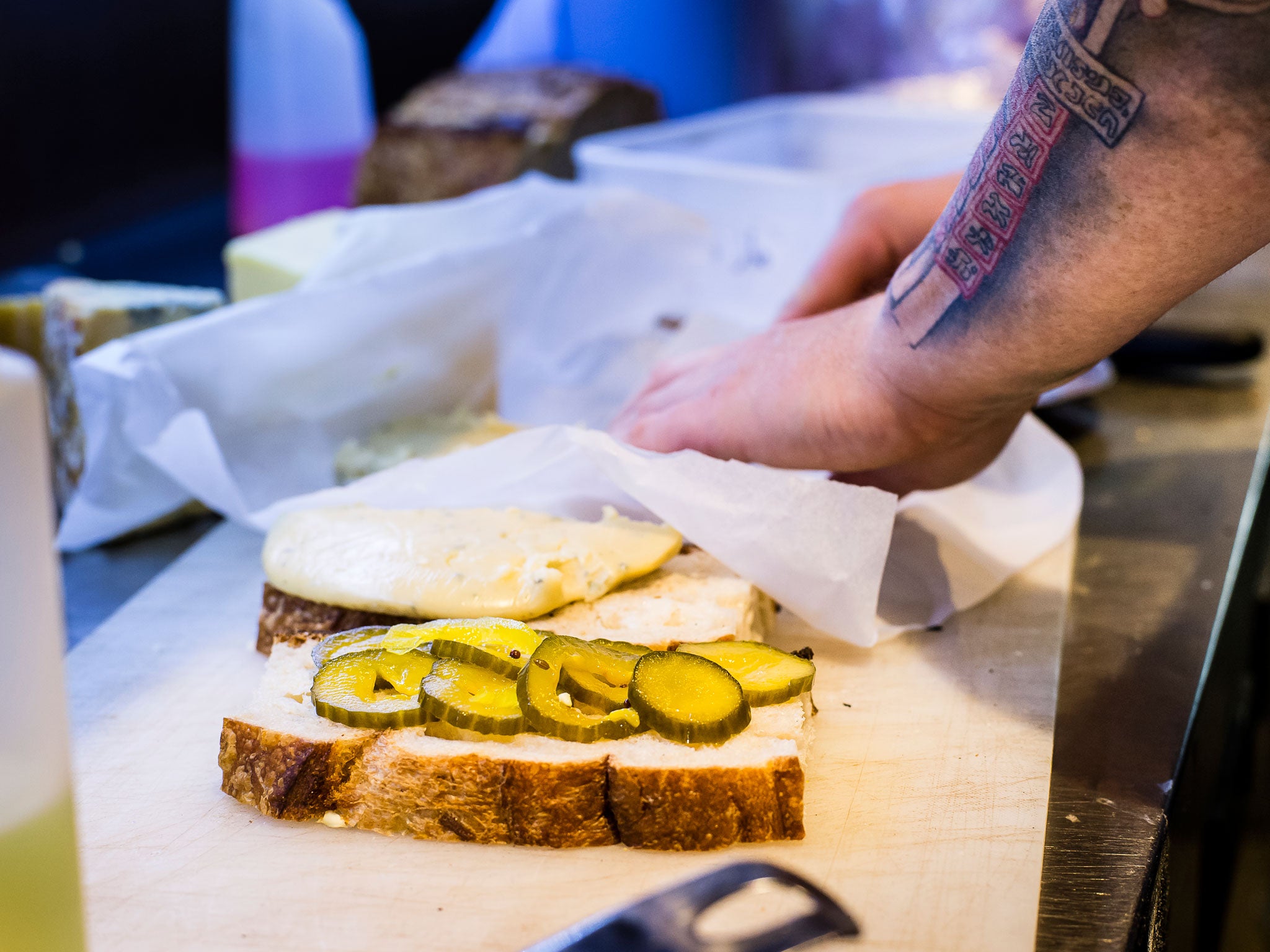 Adding pickles to the grilled beer cheese sandwich