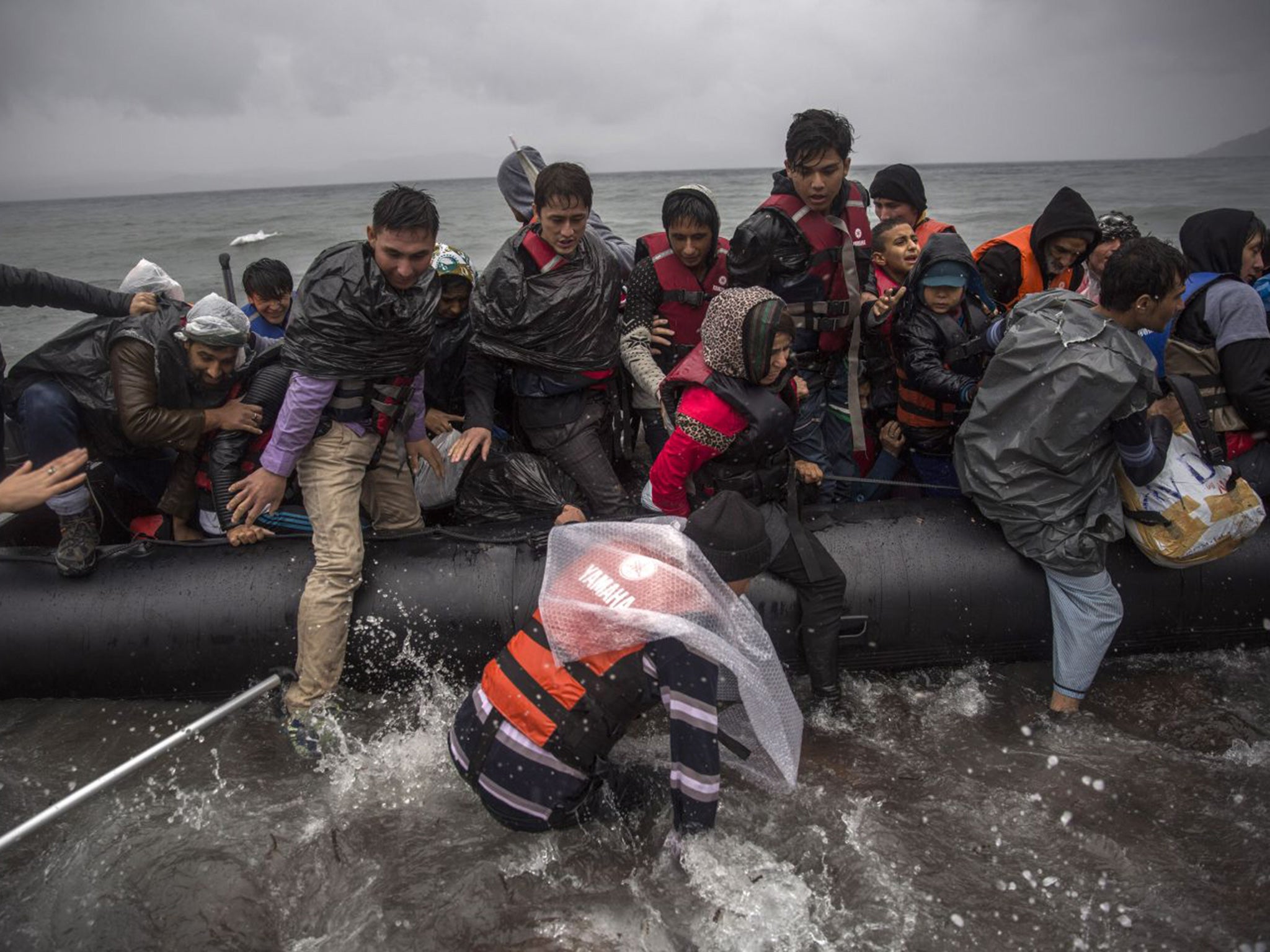 Refugees arrive on the shore of Lesbos on the morning of 23 October