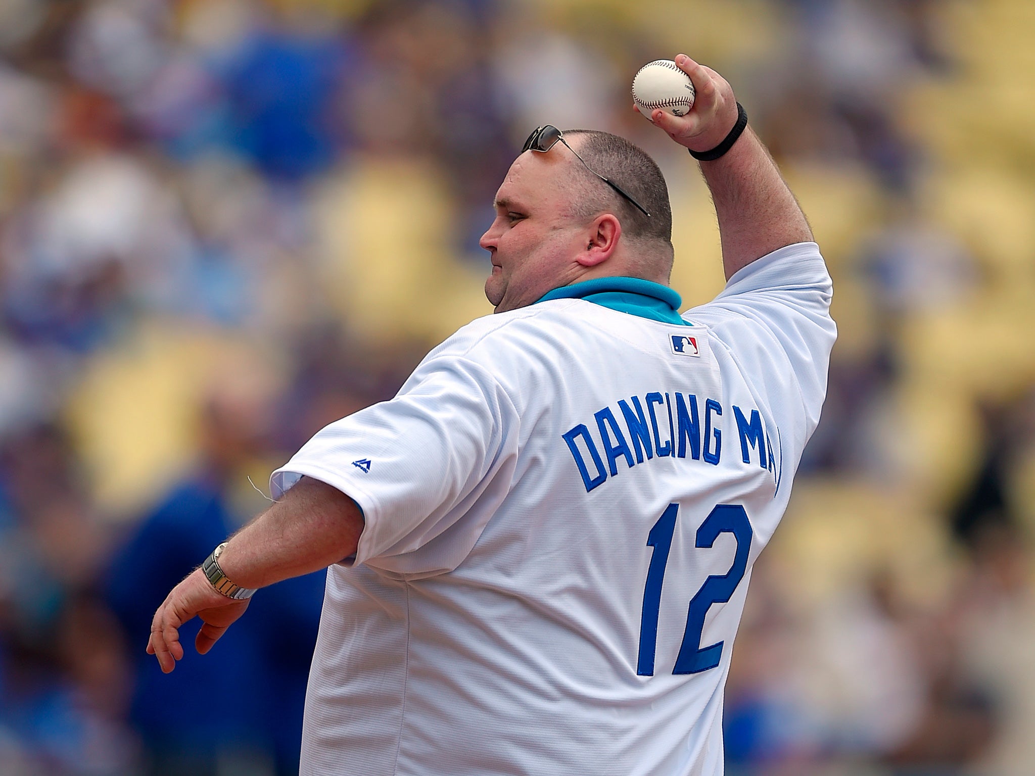 Sean O'Brien, "The Dancing Man," throws the ceremonial first pitch prior to a baseball game between the Los Angeles Dodgers and the San Diego Padres in May