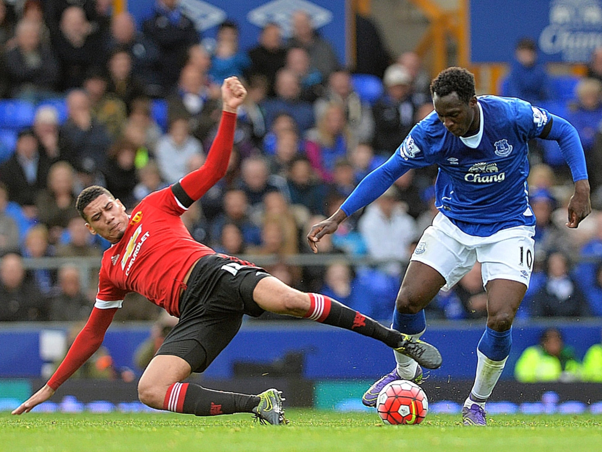 Manchester United defender Chris Smalling challenges Everton's Romelu Lukaku