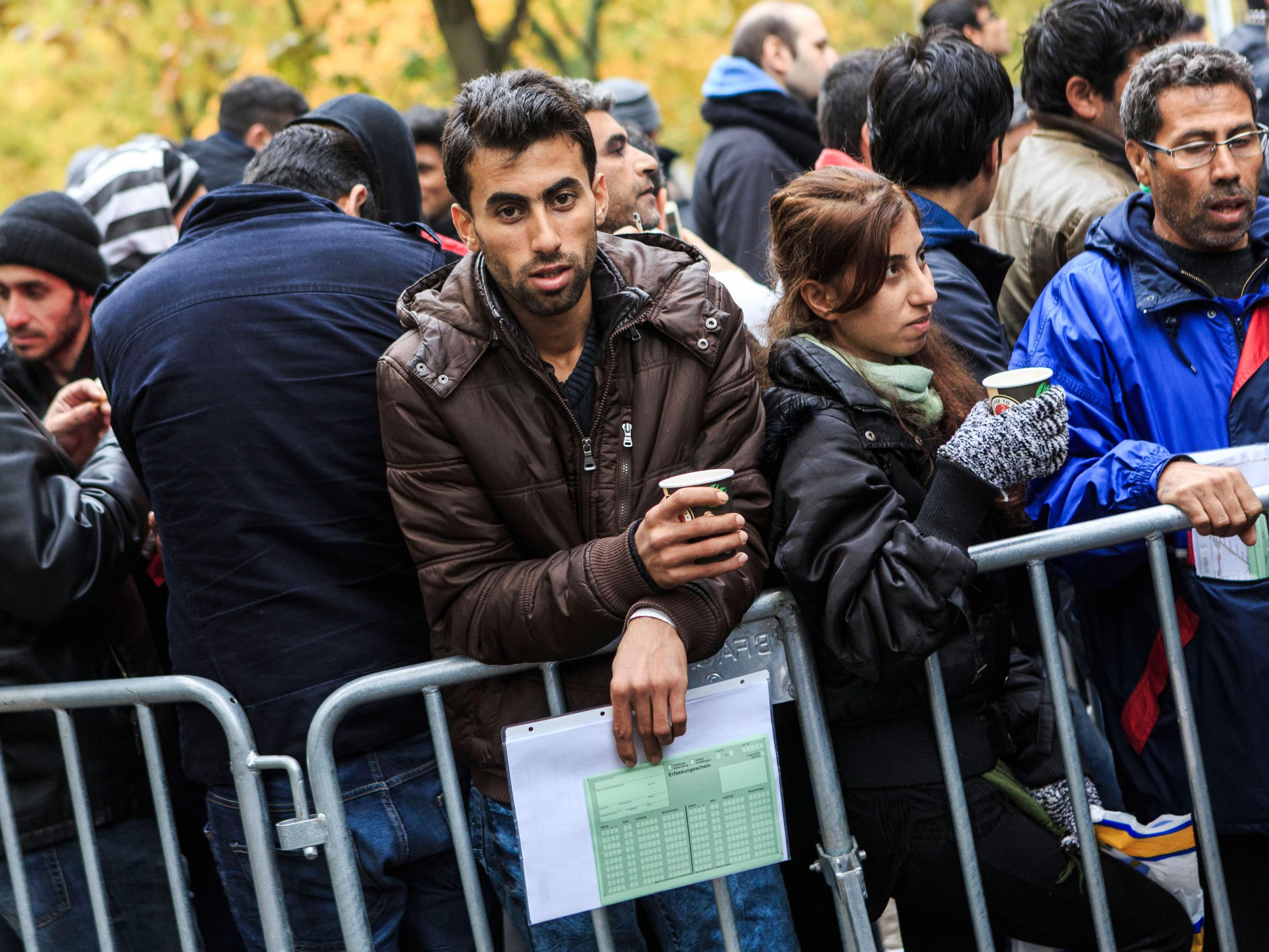 A man seeking refugee status waits to register outside the Central Registration Office for Asylum Seekers in Berlin