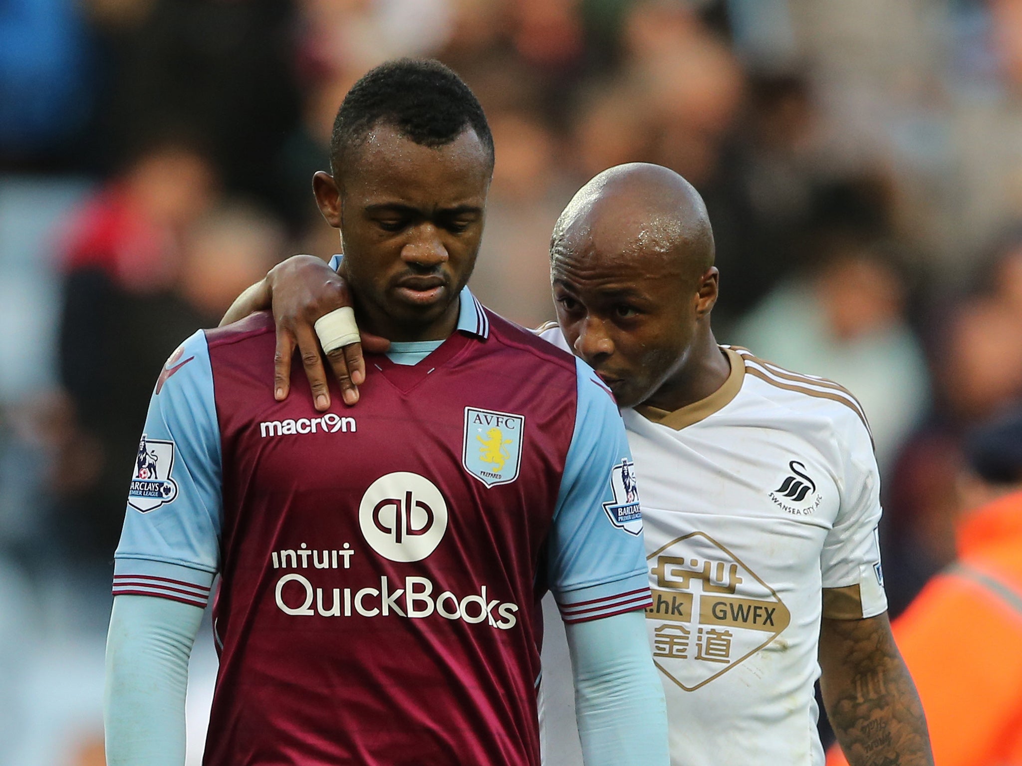 Andre Ayew, scorer of Swansea's winning goal, consoles his brother Jordan, who notched Aston Villa's opener