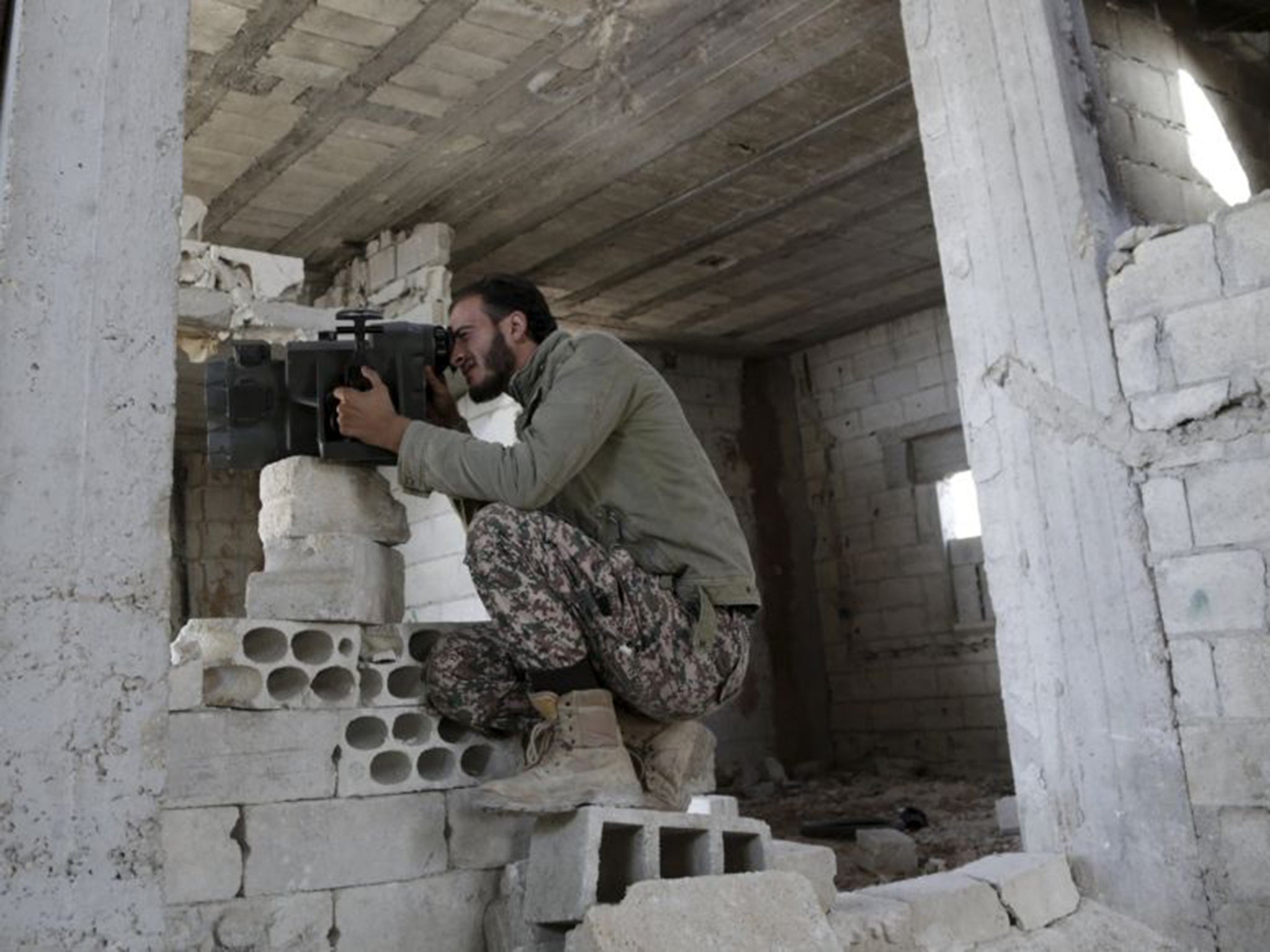 A Free Syrian Army fighter monitors the movements of forces loyal to Syria's President Bashar al-Assad. Russia has said it is open to helping the Western-backed rebels