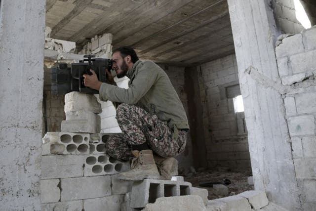 A Free Syrian Army fighter monitors the movements of forces loyal to Syria's President Bashar al-Assad. Russia has said it is open to helping the Western-backed rebels