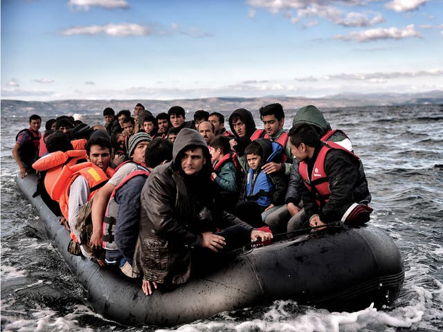 Refugees and migrants sail towards the Greek island of Lesbos on 24 October, 2015 as they cross the Aegean sea from Turkey