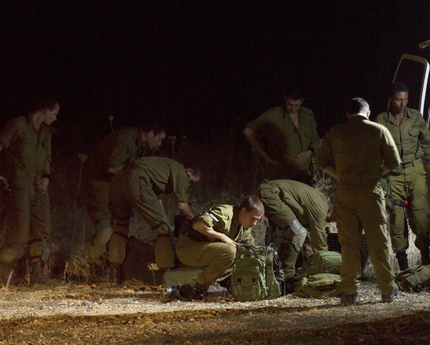 Israeli soldiers searching for the paraglider in Golan Heights on Saturday
