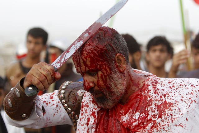 Iraq Shi'ite Muslim men bleed as they slice their foreheads with swords and beat themselves to commemorate Ashura in Sadr City, Baghdad.