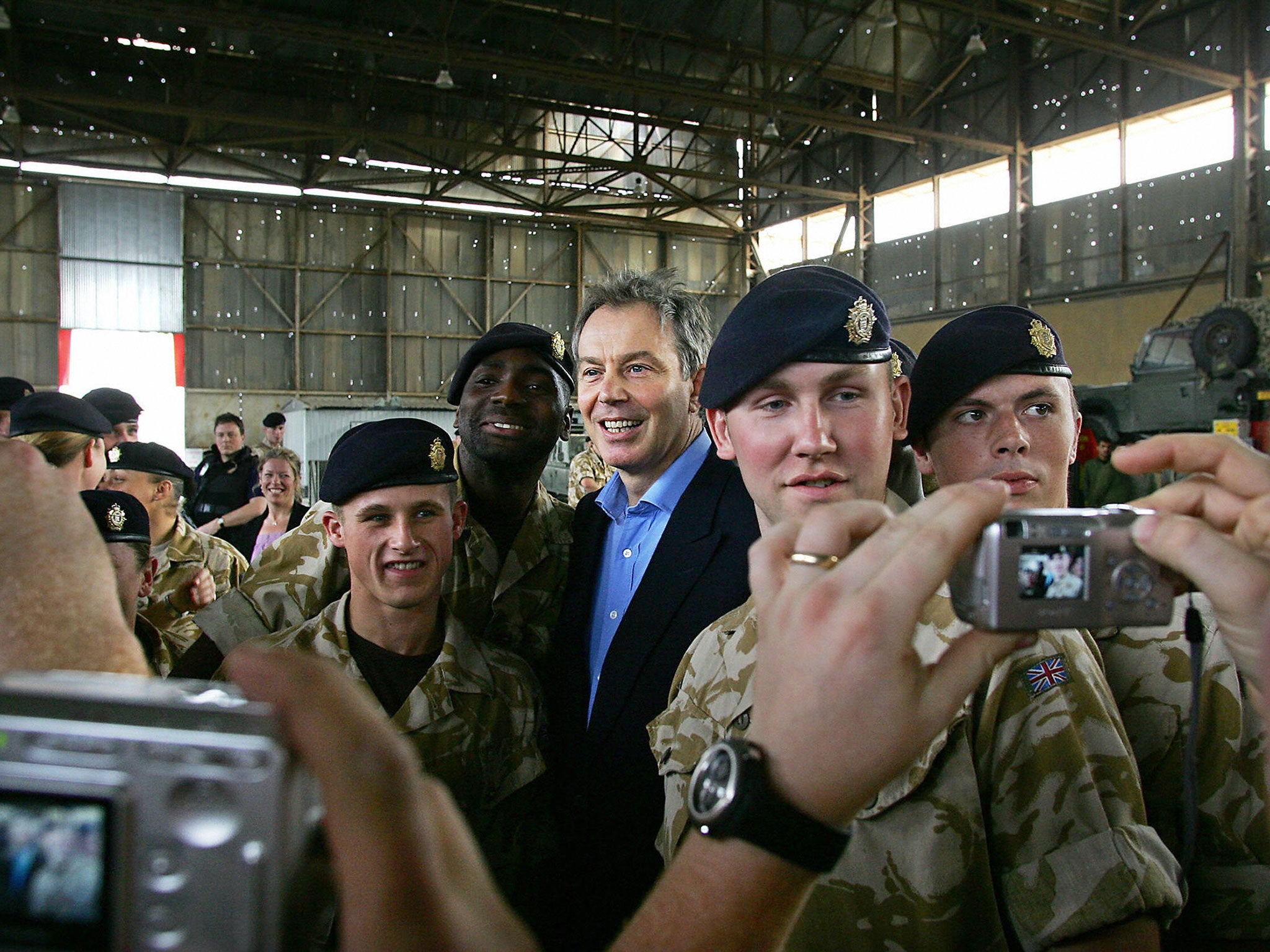 Tony Blair with British troops in Iraq in 2005. He implicitly denied on CNN he was a war criminal, saying he thought the impact of inaction in Syria was worse