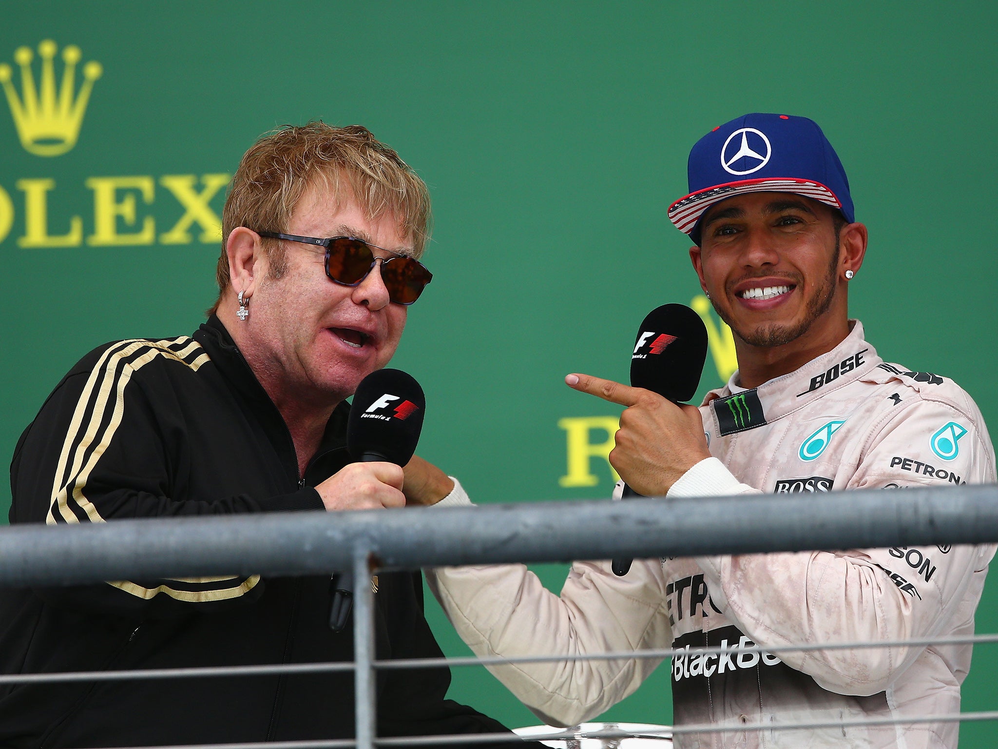 &#13;
Elton John, who had a gig nearby, on the podium with Lewis Hamilton&#13;