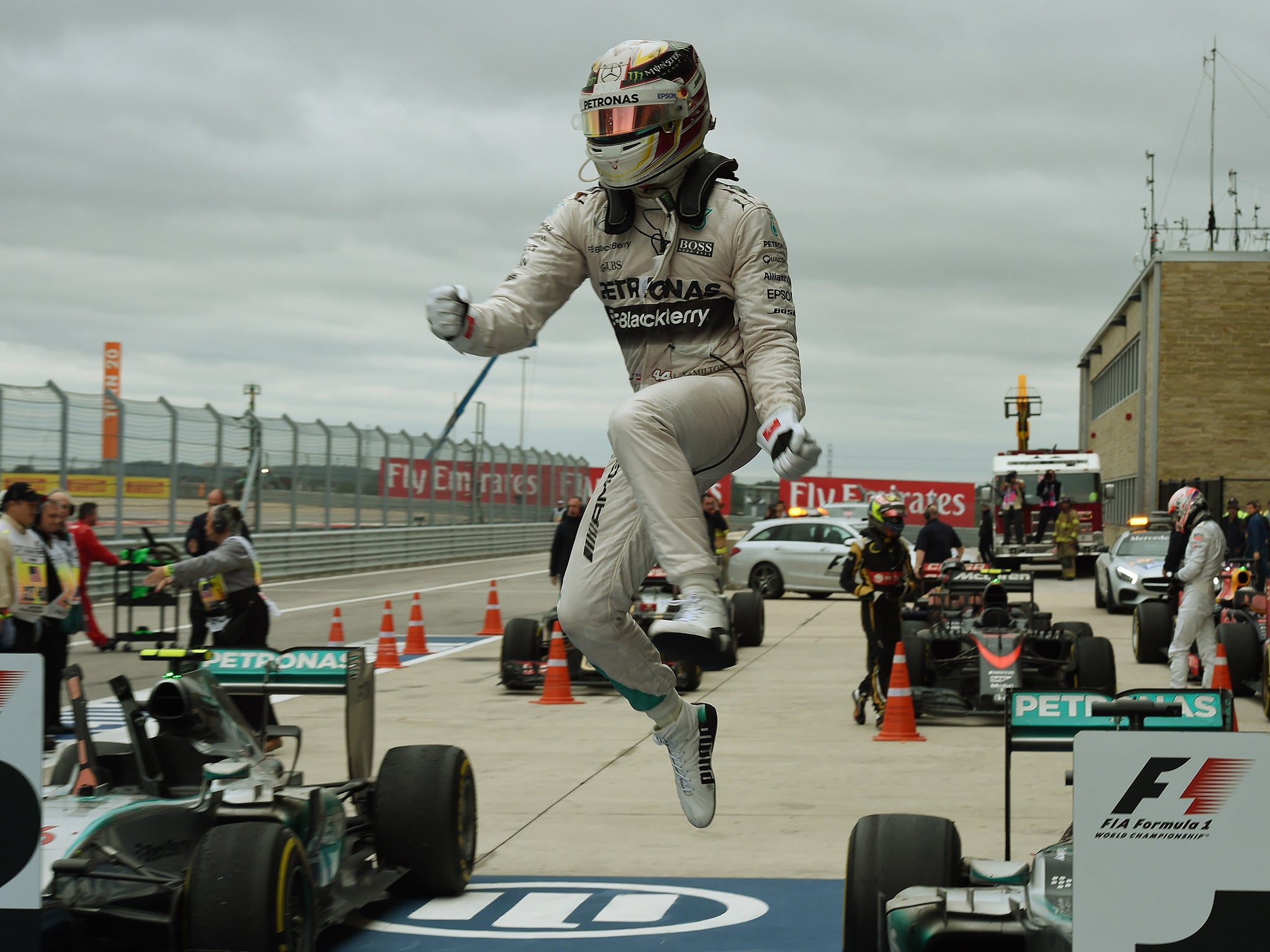 Lewis Hamilton leaps from his car in celebration