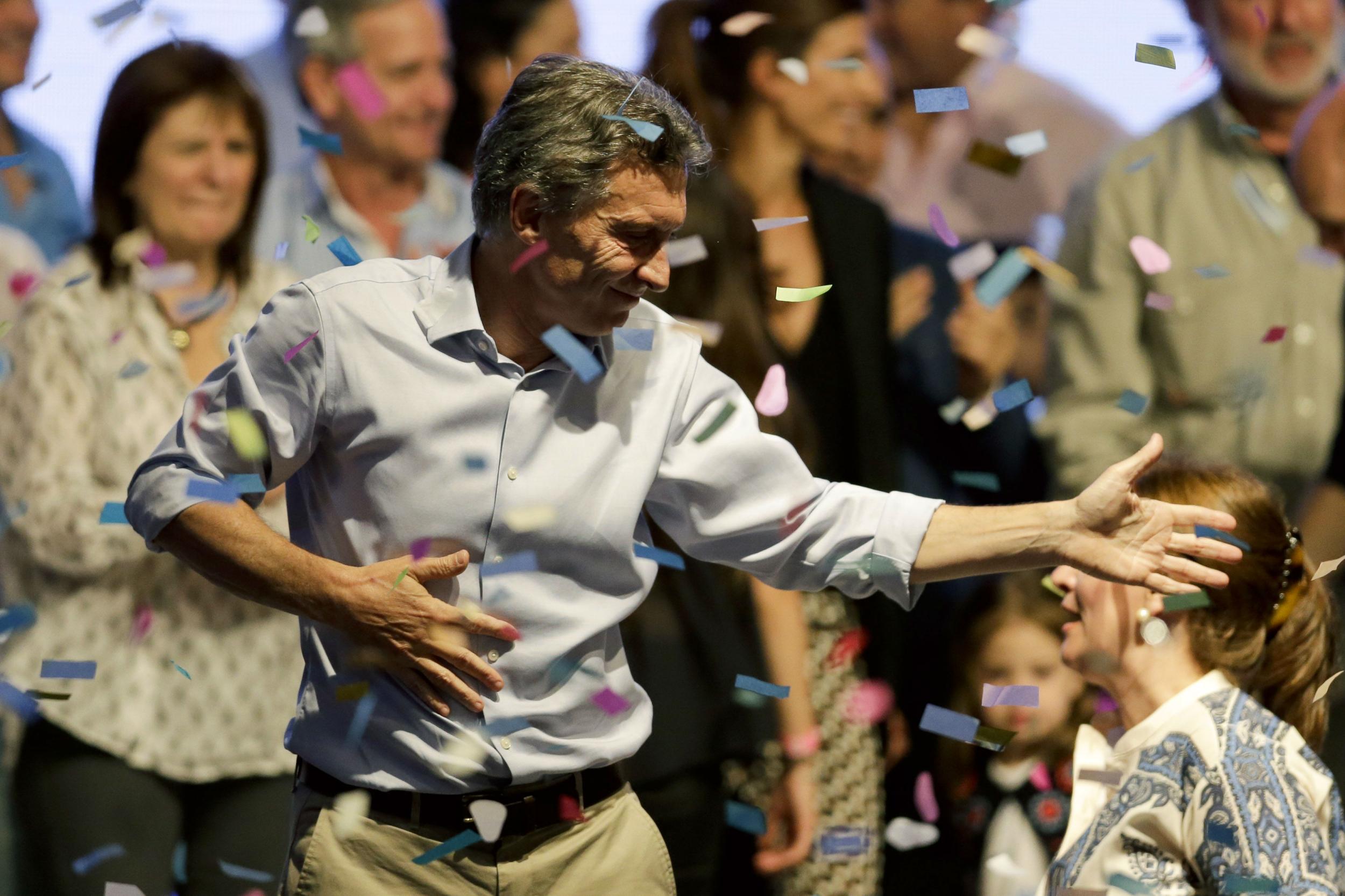 Top opposition presidential candidate Mauricio Macri dances, cheered by supporters in Buenos Aires, Argentina, Sunday, Oct. 25, 2015.