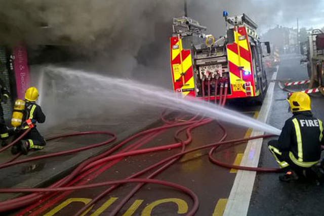 London Fire Brigade crews have rescued 25 people - including two from the roof - of a shop and flats on fire in Finchley Road
