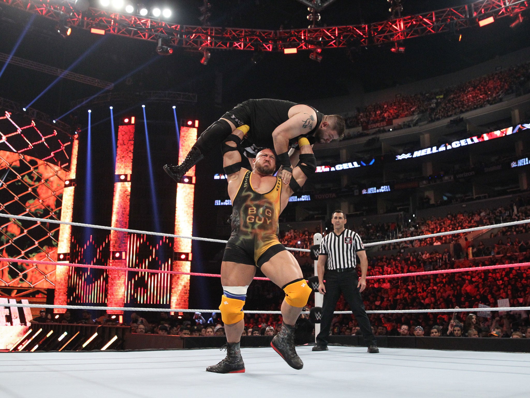 Ryback presses Kevin Owens into the air in a show of brute strength