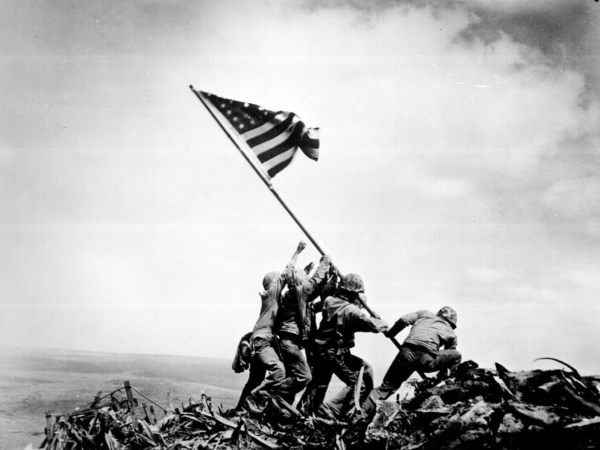 US Marines raise a flag atop Mount Suribachi during the Battle of Iwo Jima in WWII, 23 February 1945