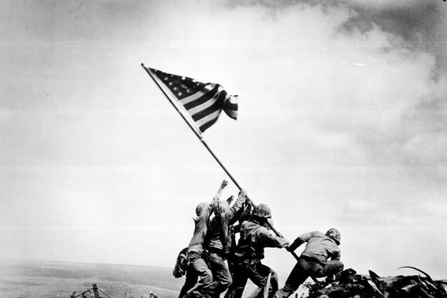 US Marines raise a flag atop Mount Suribachi during the Battle of Iwo Jima in WWII, 23 February 1945