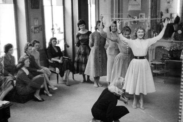 Models take part in a posture class in 1956