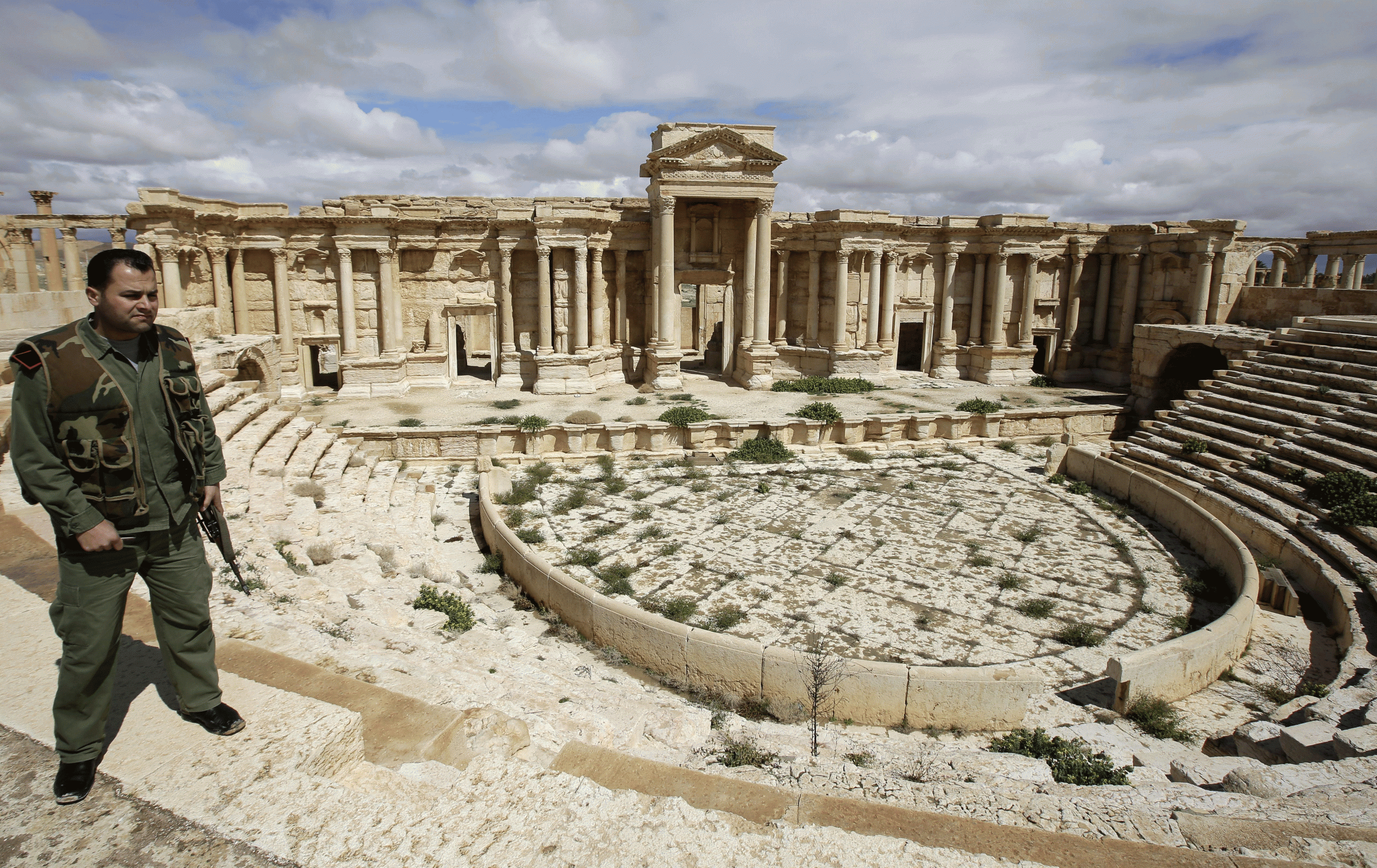 A Syrian policeman patrols the amphitheatre in Palmyra in March 2014, before it was taken over by Isis