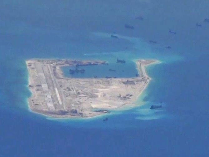 Chinese dredging vessels are seen at work near Fiery Cross Reef in the Spratly Islands