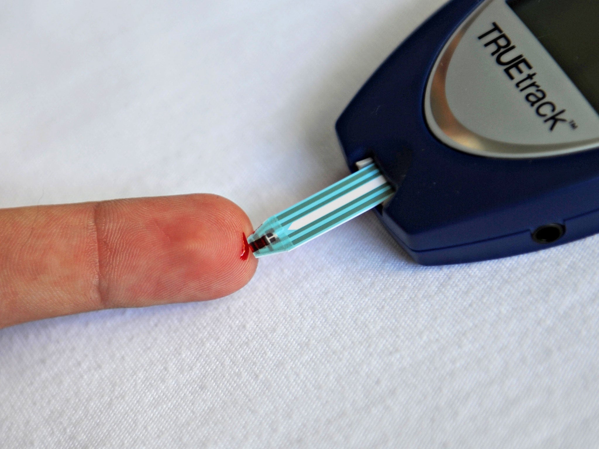 A patient with diabetes monitors his blood glucose with a glucometer